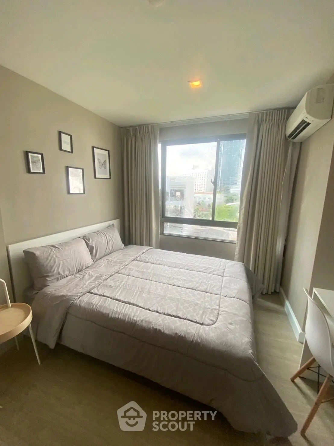 Cozy bedroom with large window and modern decor in urban apartment