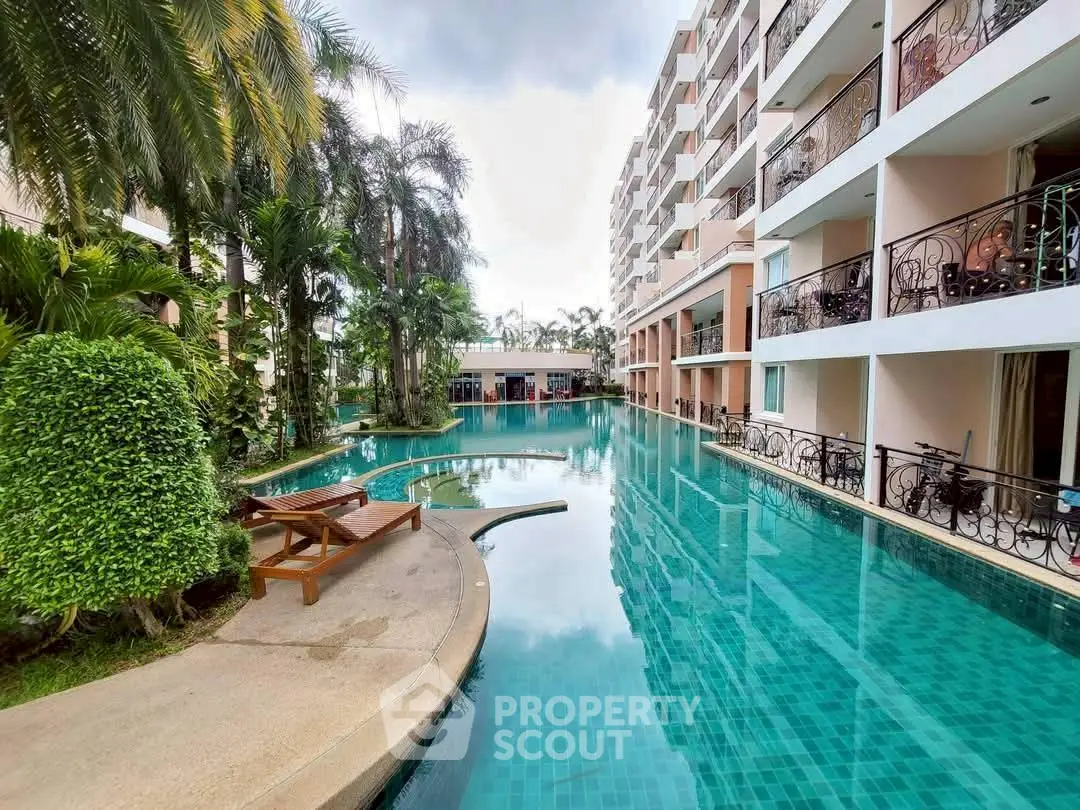 Luxurious apartment complex with stunning pool and lush greenery, perfect for resort-style living.