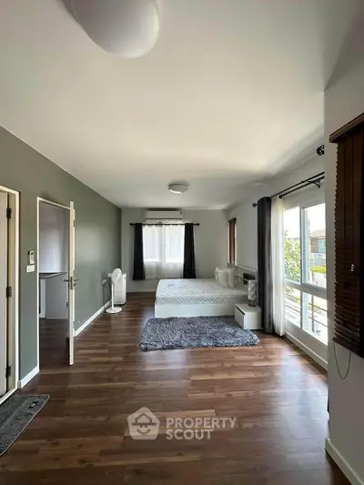 Spacious bedroom with large windows and modern decor