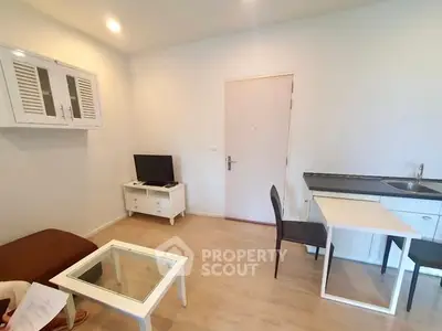 Cozy living room with modern furniture and compact kitchen area