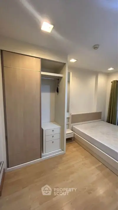 Modern bedroom with built-in wardrobe and cozy bed in stylish apartment