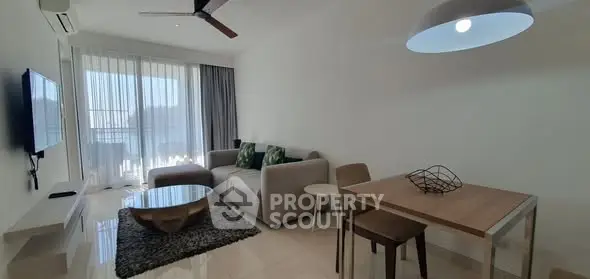 Modern living room with stylish furniture and large windows offering natural light.