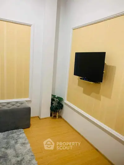 Modern living room with wall-mounted TV and stylish decor