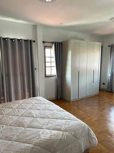 Spacious bedroom with elegant wardrobe and natural light