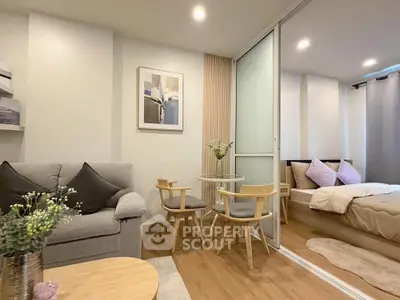 Modern studio apartment with cozy living area and stylish bedroom