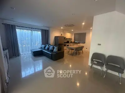 Spacious modern living room with open kitchen and sleek furnishings