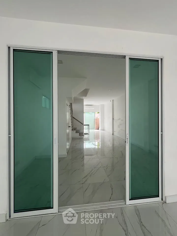 Spacious modern interior with sliding glass doors and marble flooring