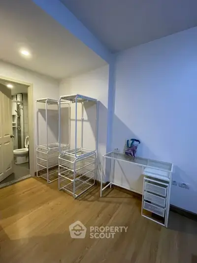 Spacious room with modern storage solutions and wooden flooring