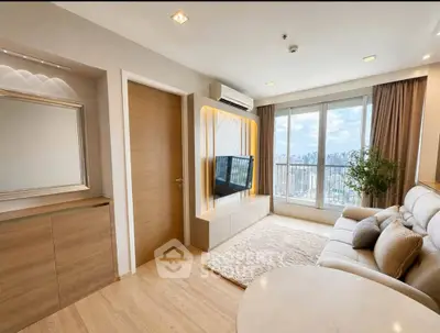 Modern living room with city view, stylish decor, and natural light.