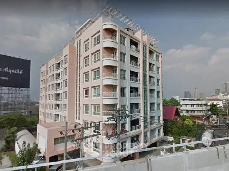 Modern multi-story apartment building with balconies in urban setting