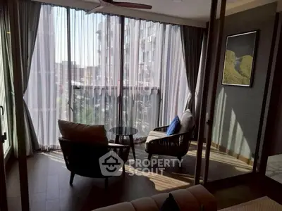 Stylish balcony with cozy seating and city view, perfect for relaxation.