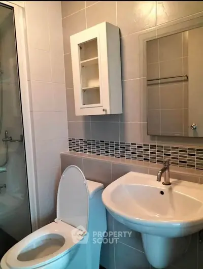 Modern bathroom with sleek fixtures and a shower enclosure