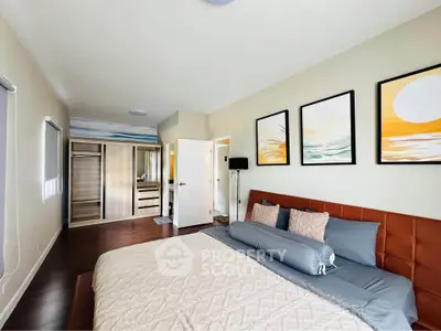 Spacious modern bedroom with stylish decor and ample natural light