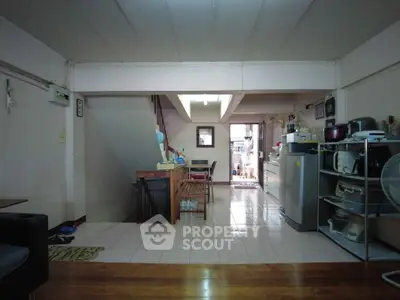 Spacious open-plan living area with kitchen and dining space, featuring modern appliances and ample natural light.