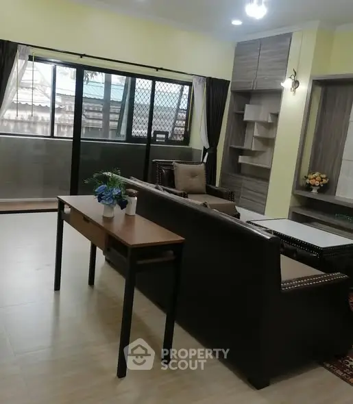 Spacious living room with modern furniture and large windows for natural light.