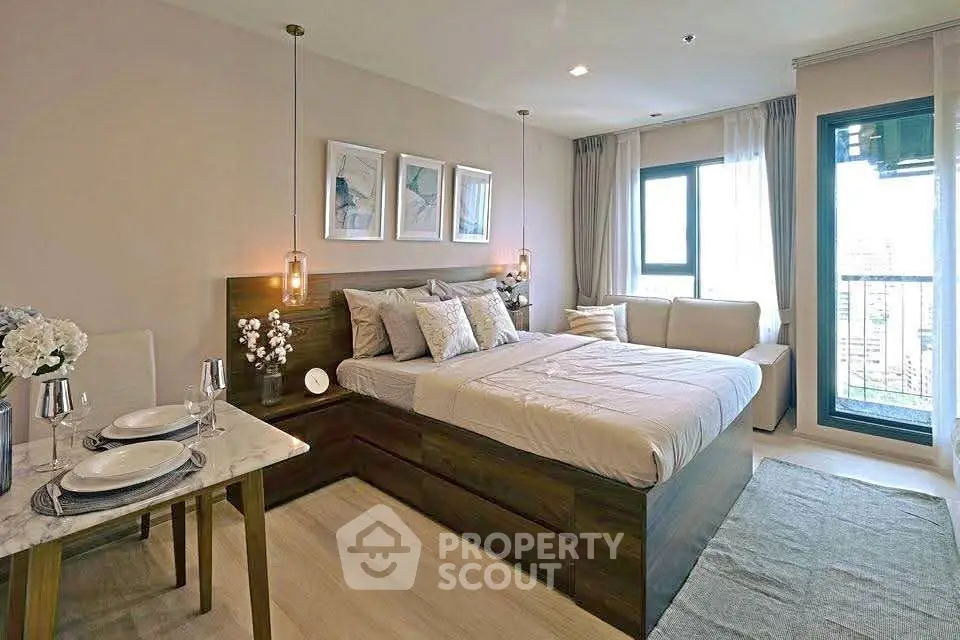 Modern bedroom with elegant decor, cozy bed, and natural light from large windows and balcony access.