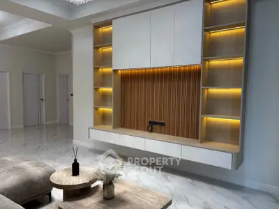 Modern living room with elegant built-in shelving and ambient lighting