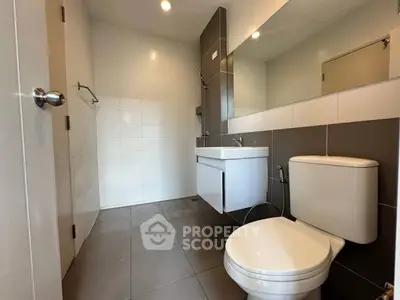 Modern bathroom with sleek fixtures and neutral tiles