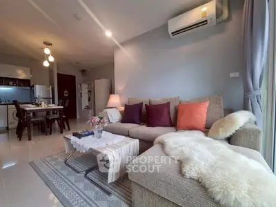 Spacious living room with cozy sofa and modern decor in open-plan apartment