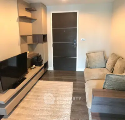 Cozy living room with modern decor and comfortable seating in a stylish apartment.