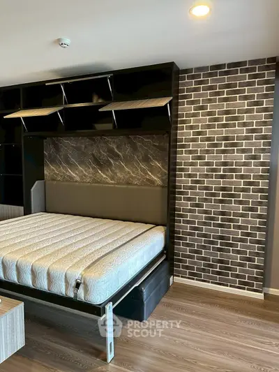 Modern bedroom with stylish brick accent wall and built-in shelving