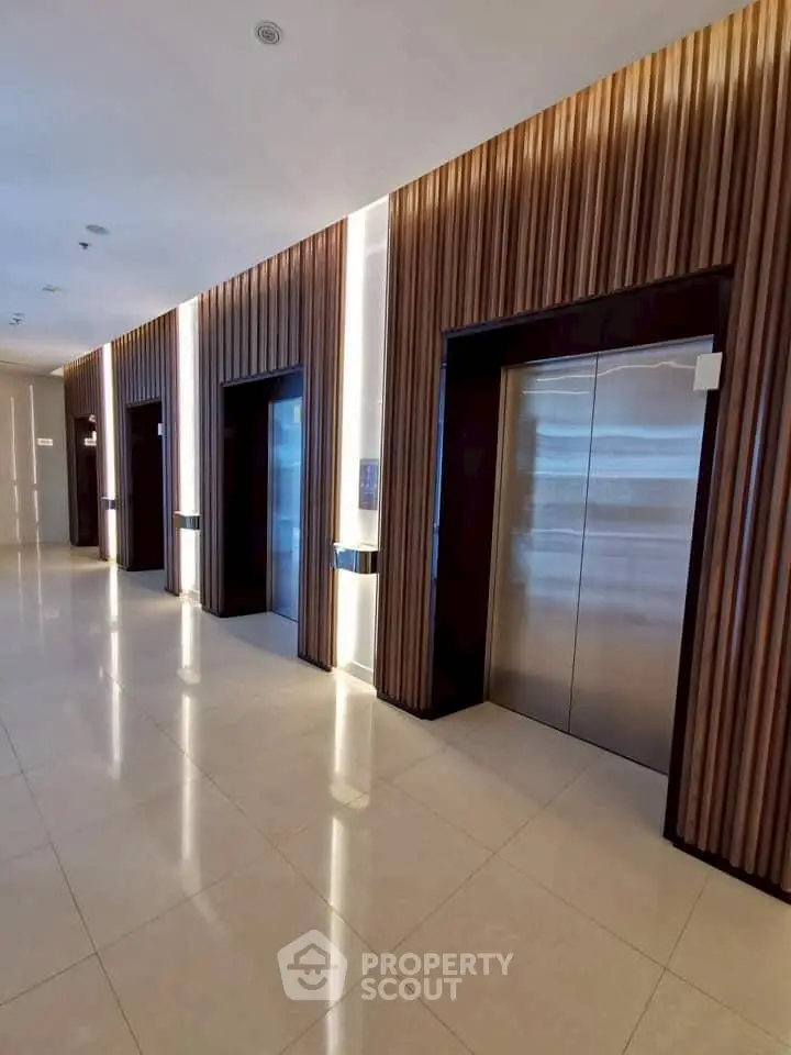 Modern elevator lobby with sleek design and ambient lighting