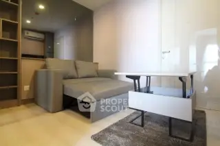 Modern living room with stylish gray sofa and sleek coffee table in a cozy apartment setting.