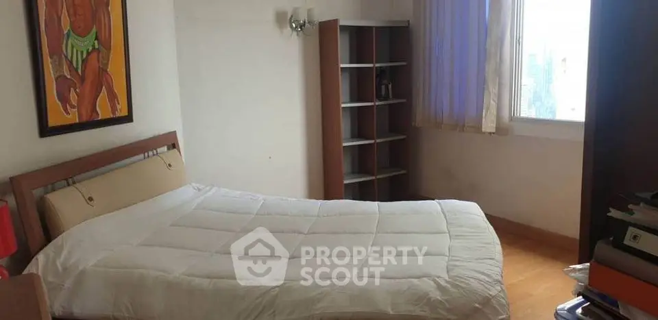 Cozy bedroom with natural light and modern decor in a stylish apartment.