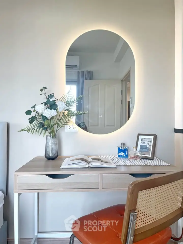 Modern study nook with stylish desk, mirror, and decor in a cozy home setting.
