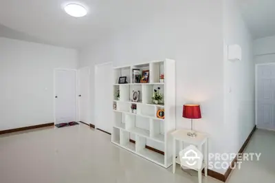 Spacious modern living room with elegant shelving and ambient lighting