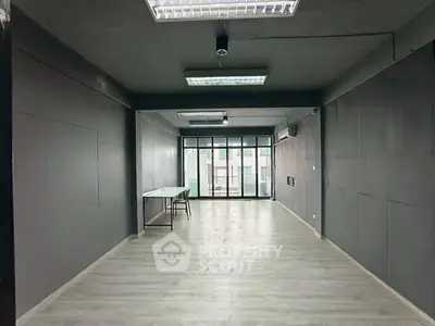 Spacious modern interior with large windows and sleek flooring, ideal for versatile use.