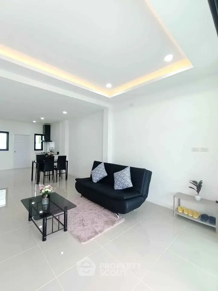 Modern living room with sleek black sofa and stylish decor