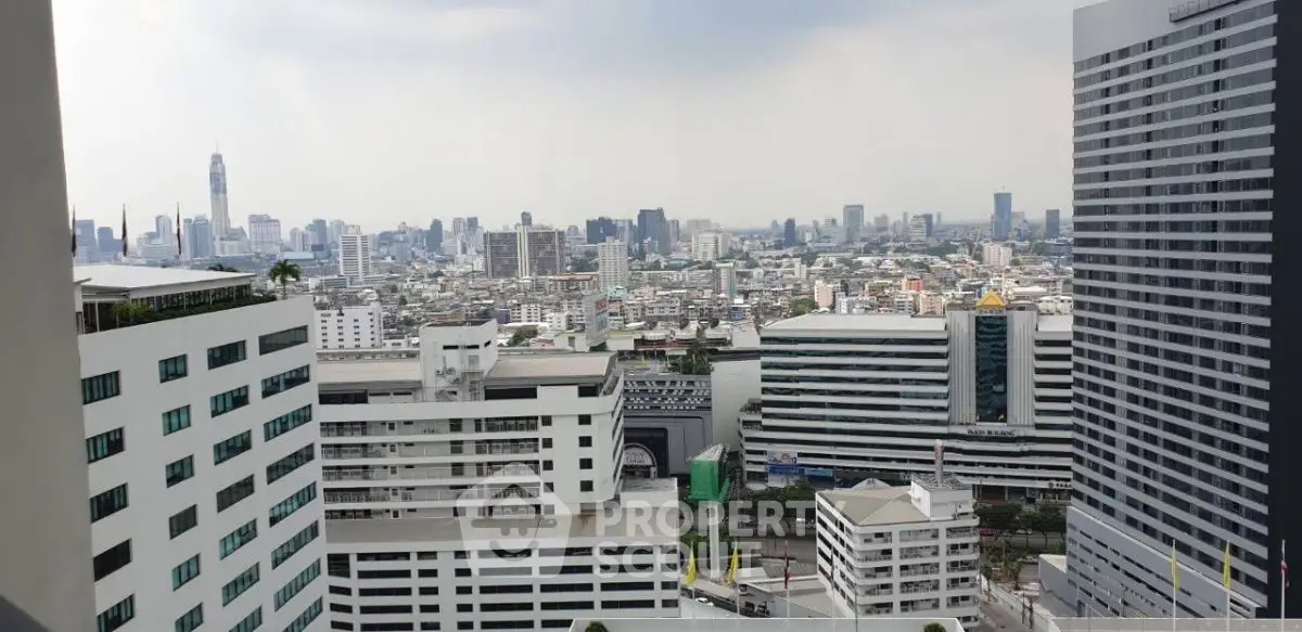 Stunning cityscape view from high-rise building balcony, showcasing urban skyline and modern architecture.