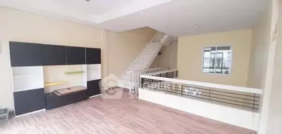 Spacious open-plan living area with modern staircase and sleek flooring