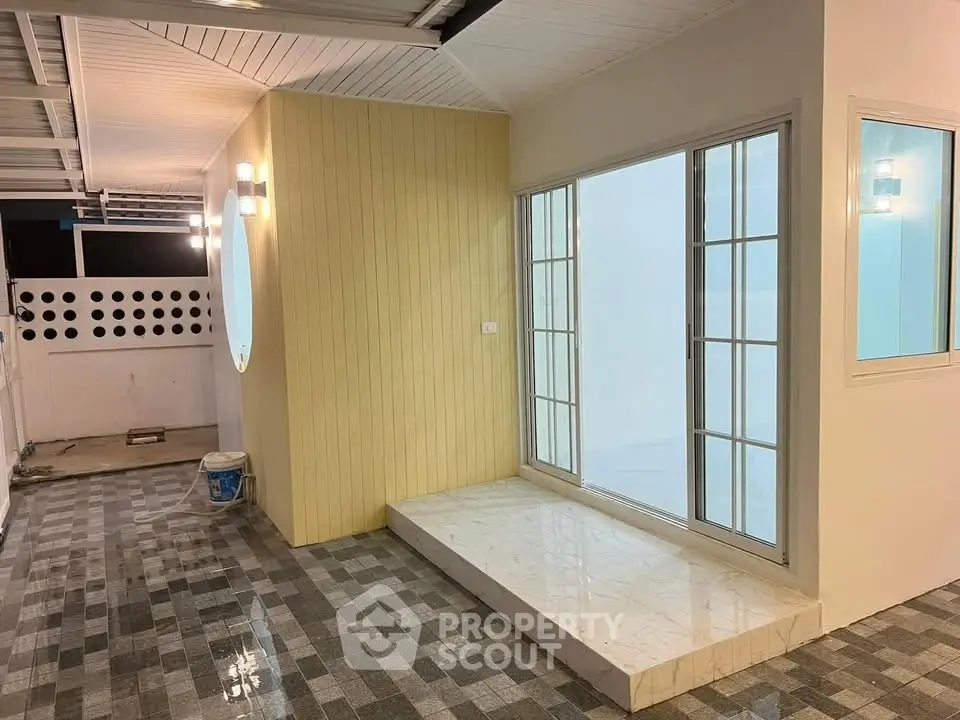 Modern home entrance with stylish tiled flooring and large glass doors