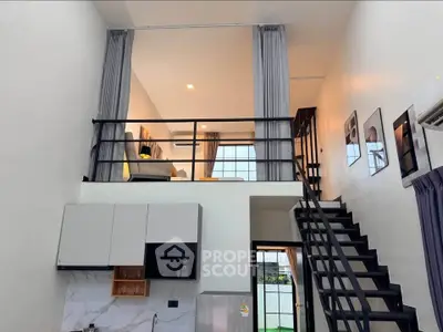 Modern loft apartment with mezzanine, sleek kitchen, and stylish staircase, perfect for urban living.