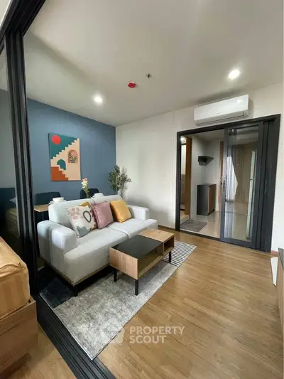 Modern living room with stylish decor and wooden flooring in a cozy apartment.