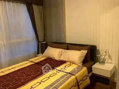 Cozy bedroom with modern decor and natural light, featuring a stylish bed and elegant curtains.