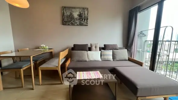 Modern living room with stylish furniture and balcony view