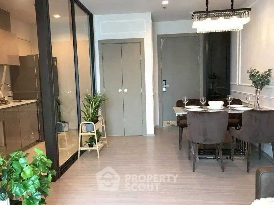 Modern dining area with glass partition and elegant decor