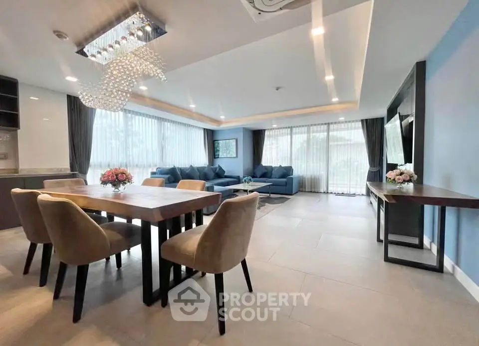 Spacious modern living room with elegant dining area and large windows