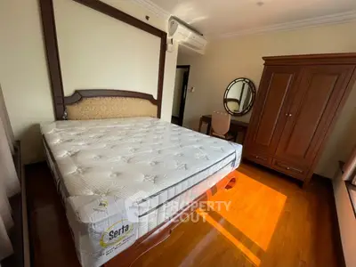 Spacious bedroom with elegant wooden furniture and natural light