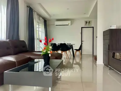 Modern living room with sleek furniture and elegant decor, featuring a spacious layout and natural light.