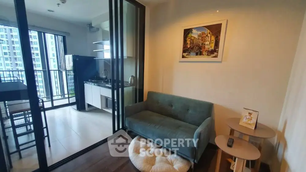 Modern condo living room with open kitchen and balcony view
