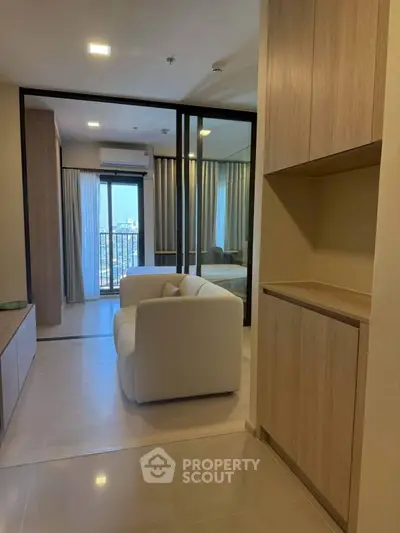 Modern apartment interior with cozy living area and balcony view