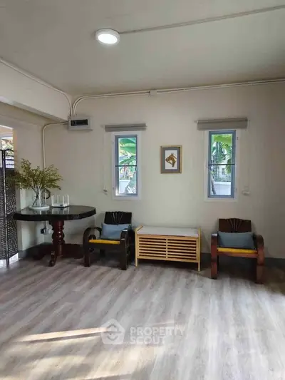 Charming interior with elegant seating and natural light, perfect for a cozy living space.