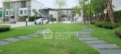 Modern residential area with lush green lawn and pathway