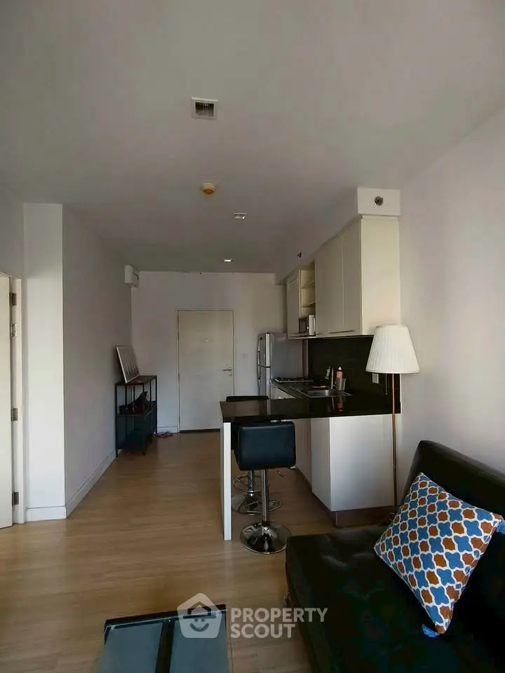 Modern open-layout apartment with sleek kitchen and cozy living area.