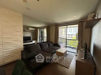 Modern living room with large sofa and balcony view in stylish apartment