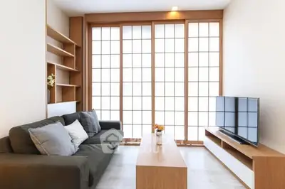 Modern living room with sleek furniture and large windows for natural light.